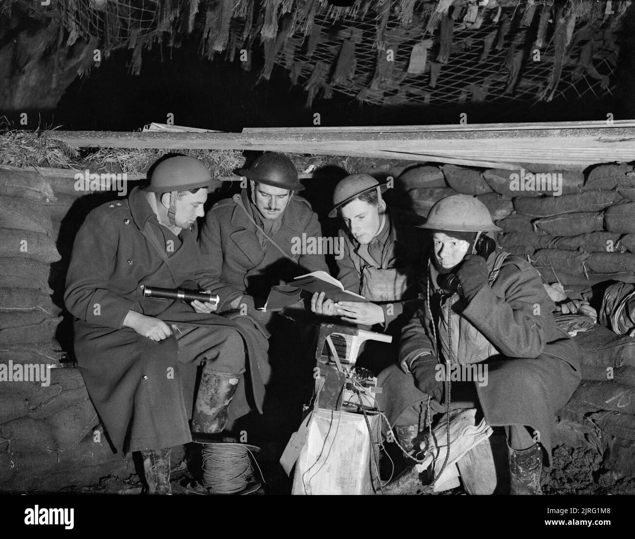 The cramped interior of the battery commander's dugout at a 25-pdr field gun battery near Mouchin, France, 29 November 1939. The cramped interior of the battery commander's dugout at a 25-pdr field gun battery near Mouchin, 29 November 1939. Stock Photo