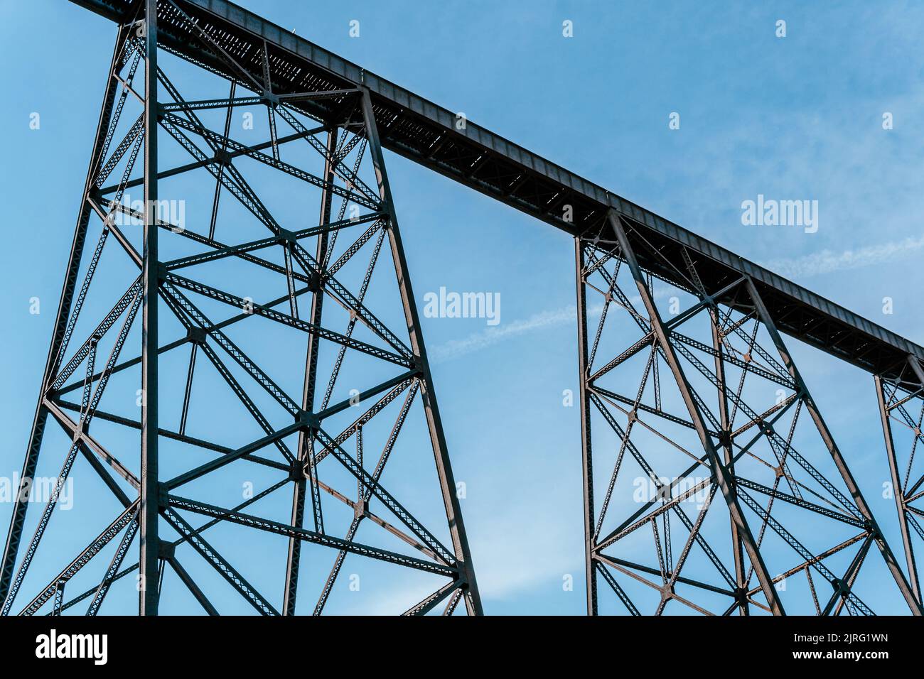 A tall train bridge viaduct engineered with iron steel trusses and