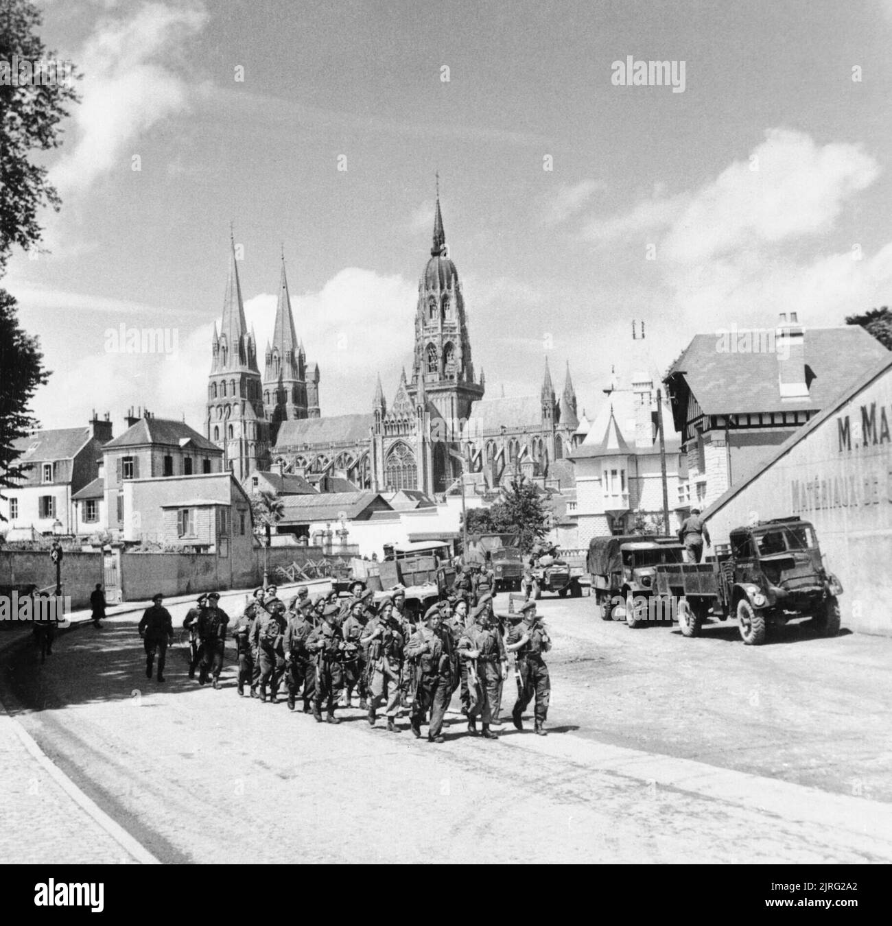 British troops marching through Bayeux in Normandy, 27 June 1944. Troops marching through Bayeux, with the cathedral in the background, 27 June 1944. Stock Photo