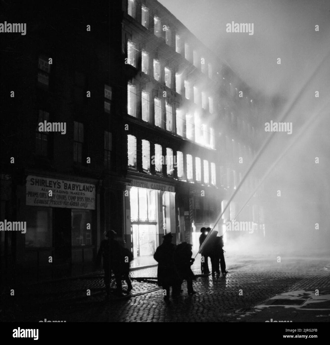 Buildings burning in Manchester after a German air raid on the night of ...