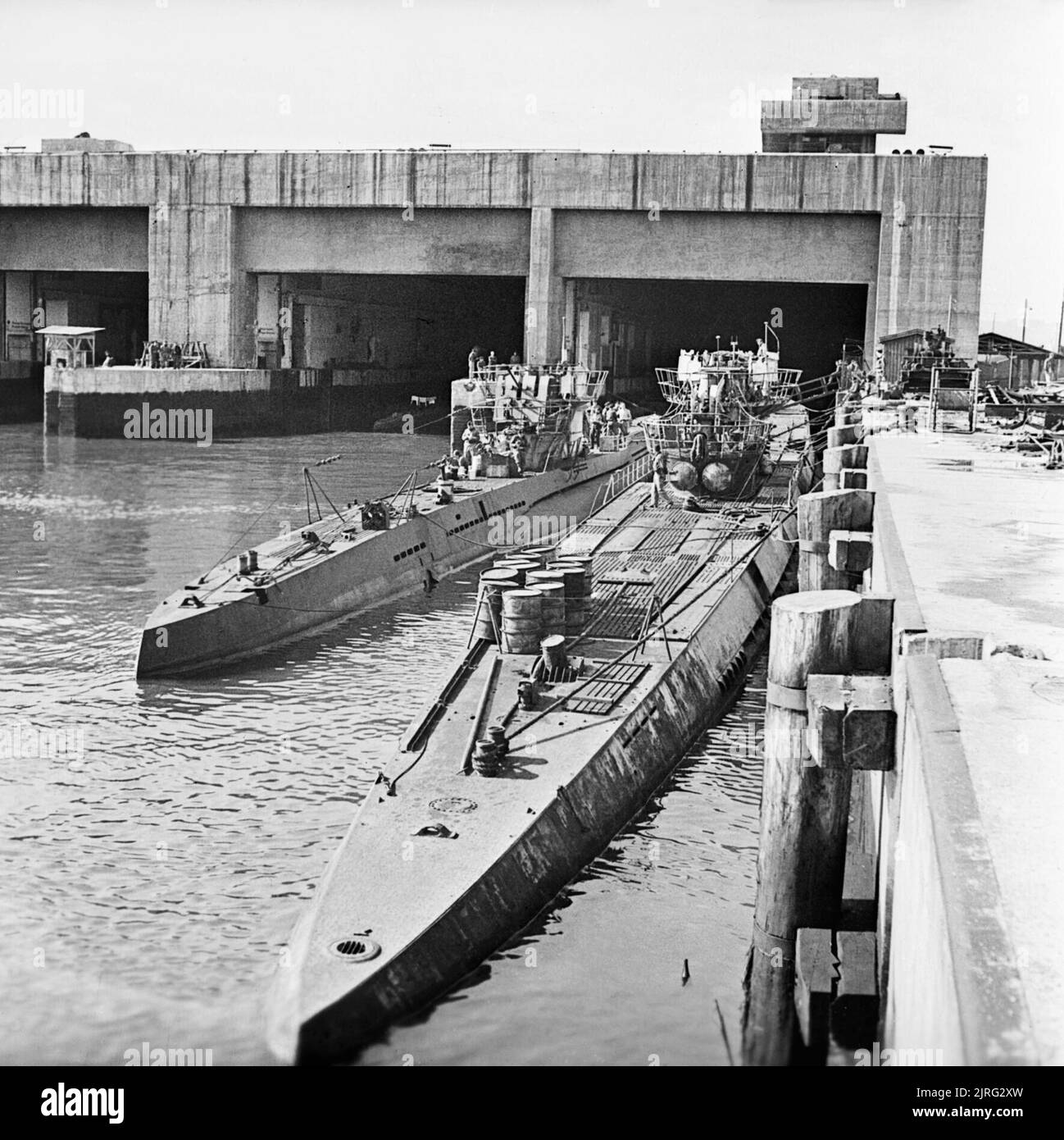 Captured German U-boats outside their pen at Trondheim in Norway, 19 May 1945. Axis Forces: A Type VII and a Type IX submarine alongside each other outside the submarine pens at Trondheim after the war. Stock Photo