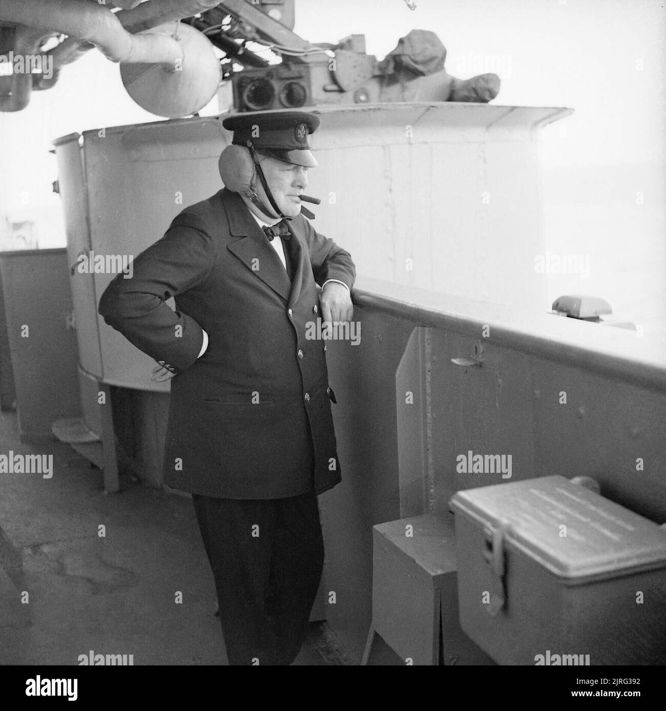 Winston Churchill wearing leather ear defenders watches gunnery practice on board HMS RENOWN whilst he was returning from Canada, September 1943. The Prime Minister Winston Churchill wearing leather earguards watching gunnery practice on board HMS RENOWN whilst he was returning from Canada. Stock Photo