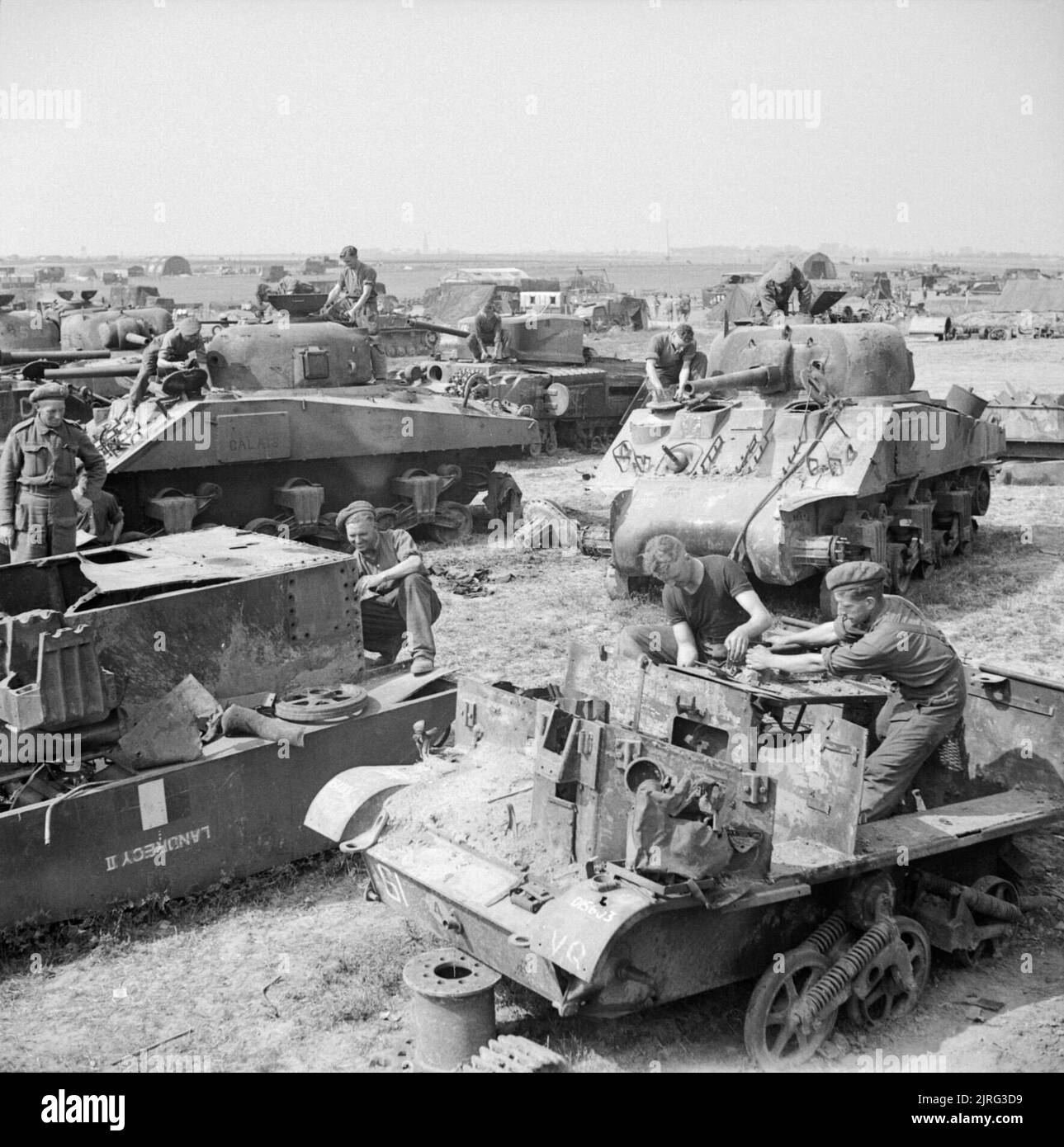 Wrecked Sherman tanks and carriers being broken up at a British salvage