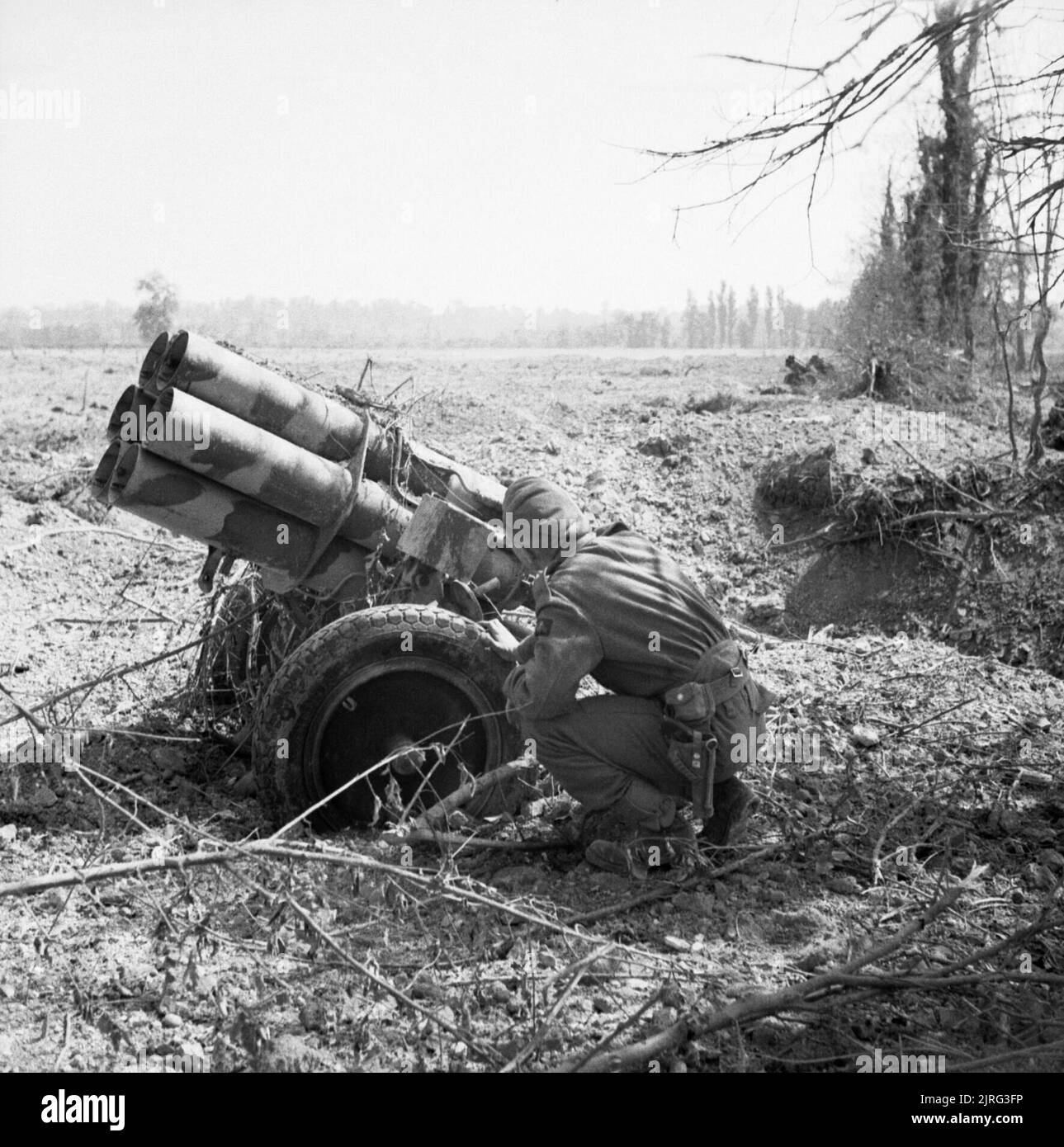 A British soldier examines an abandoned German 'Nebelwerfer' near Troarn, Normandy, 20 July 1944. A soldier examines an abandoned German 'Nebelwerfer' near Troarn, 20 July 1944. Stock Photo