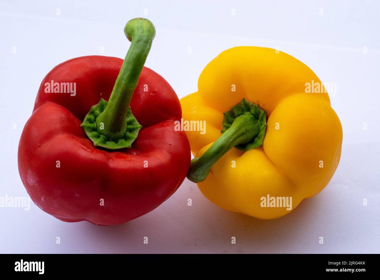 Red and yellow pepper on white background Stock Photo - Alamy