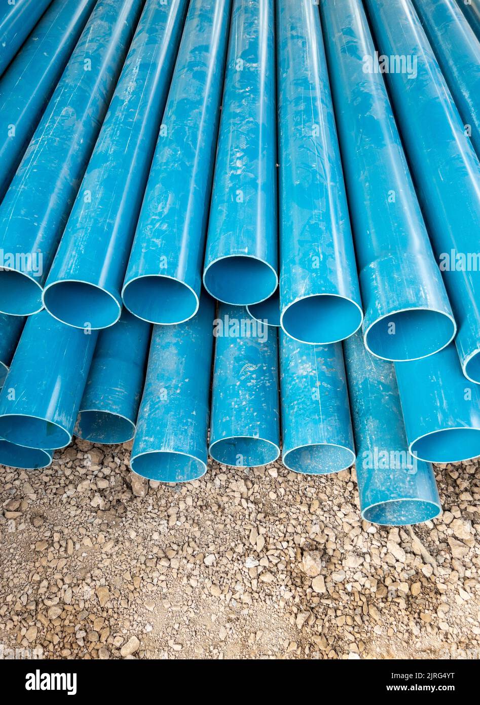 The new PVC pipe pile near the construction site for the preparation of the water supply system