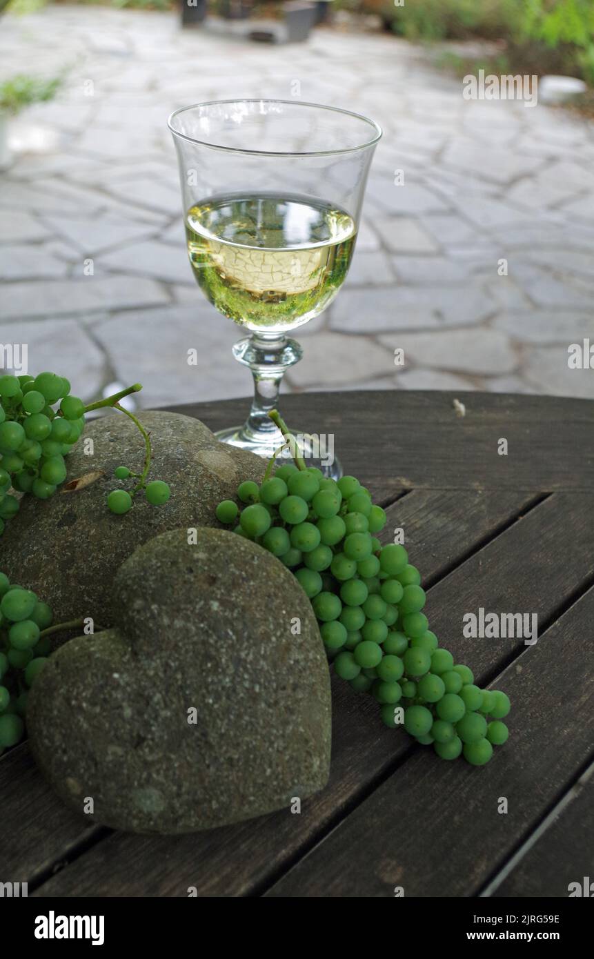 A Glass of White Wine. Different Decorations. Stock Photo