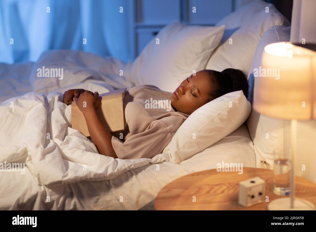 african woman sleeping in bed at home at night Stock Photo Alamy