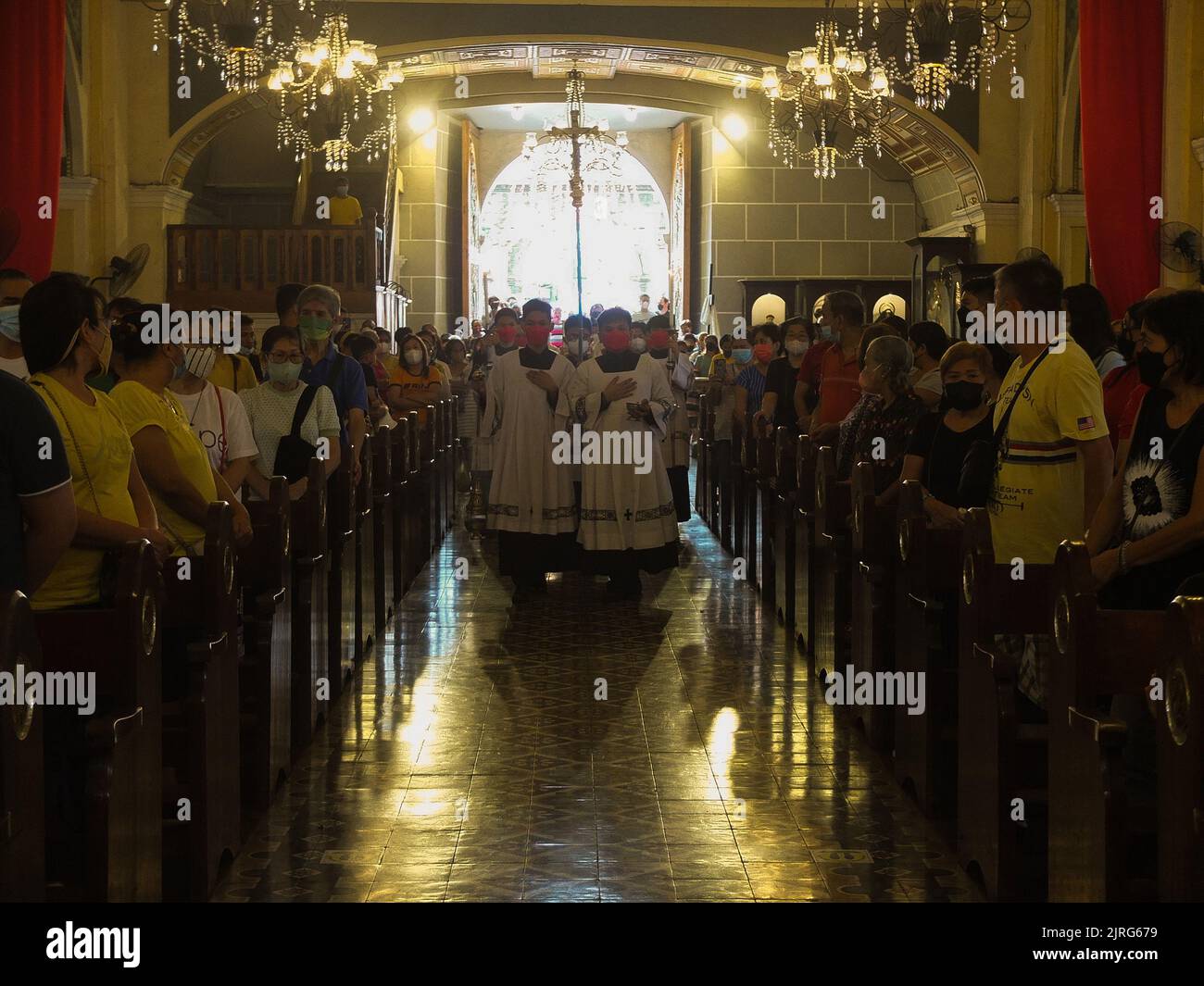 Malabon, Philippines. 24th July, 2022. The Bishop entourage walks in at the church aisle. Malabon City residents Observe the Feast of St. Bartholomew or San Bartolome, One of the twelve apostles of Jesus Christ every August 24th of the year. Local residents go to church to hear Holy Mass or the ''Misa Concelebrada'' or mass concelebrated by more than ten priests, to pray and give thanks for the blessings they received. (Credit Image: © Josefiel Rivera/SOPA Images via ZUMA Press Wire) Stock Photo