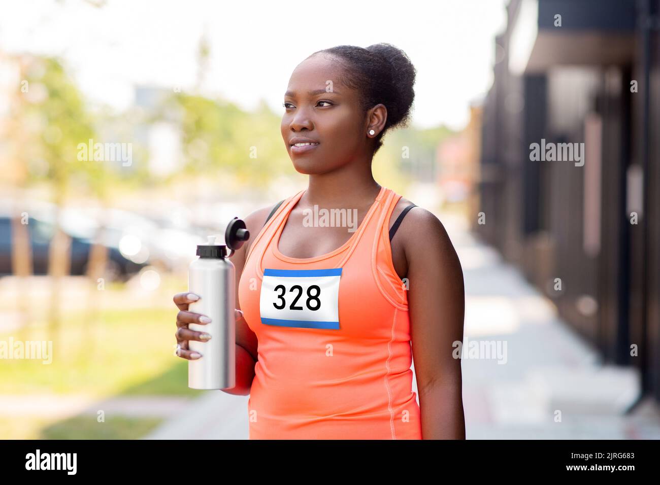 female marathon runner drinking water from bottle Stock Photo Alamy