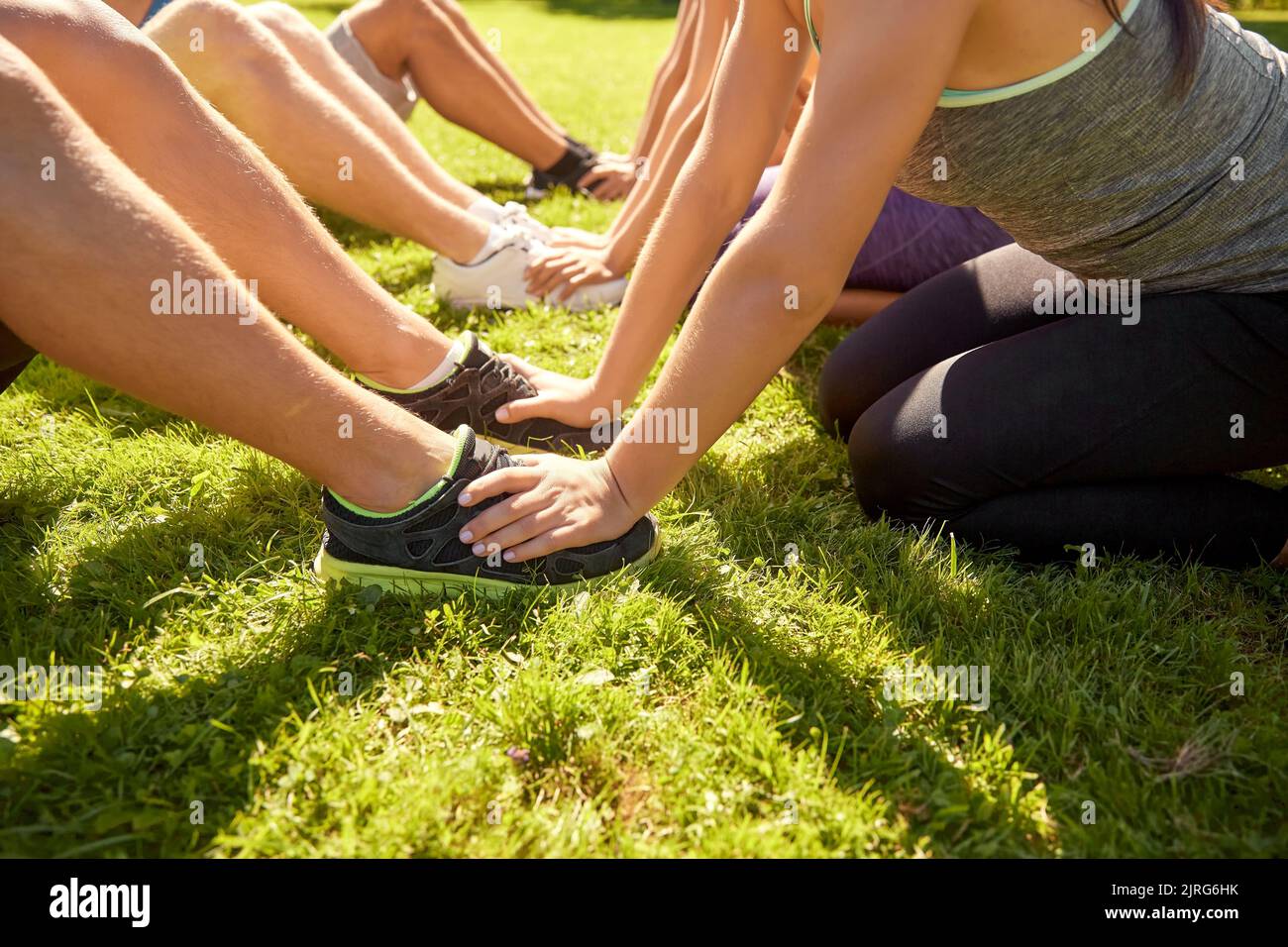 close up of people exercising at park Stock Photo