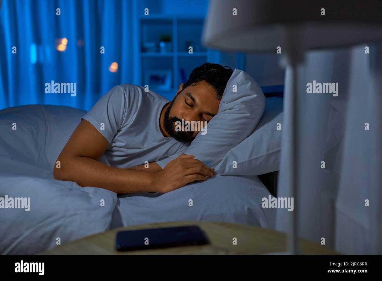 indian man sleeping in bed at home at night Stock Photo Alamy