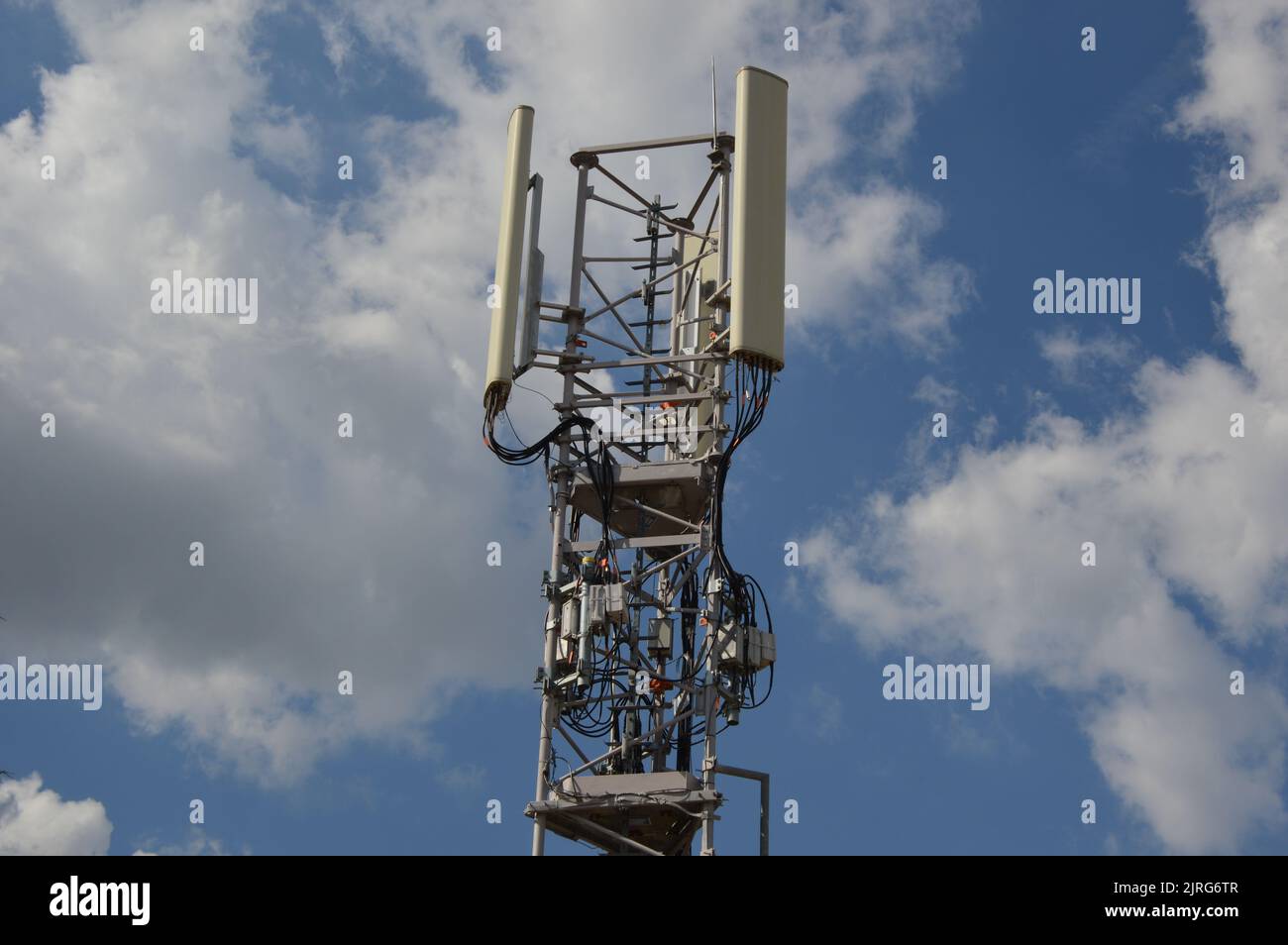 A Telecommunication antenna mast with a slightly cloudy background, France Stock Photo