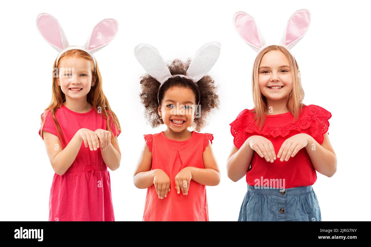 happy girls wearing easter bunny ears headbands Stock Photo Alamy