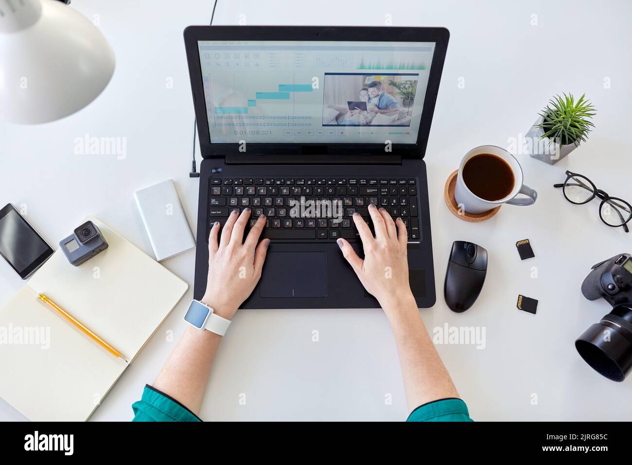 woman with video editor program on laptop at home Stock Photo