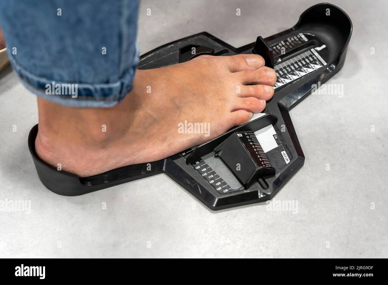 Woman Measuring Shoe Size In Storage Device Determining Length Foot 