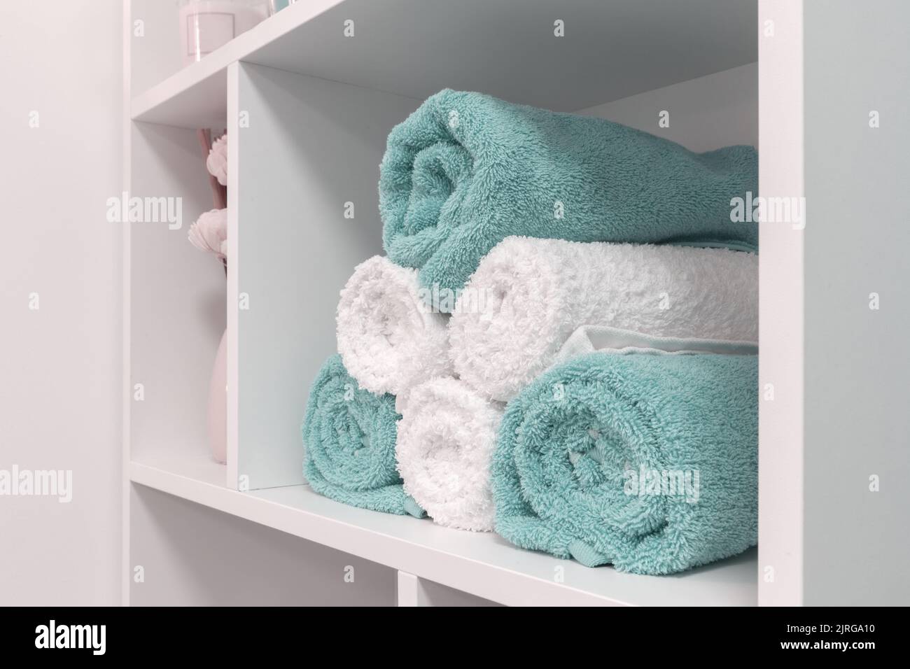folded towels in the shelf, close up, white and blue Stock Photo