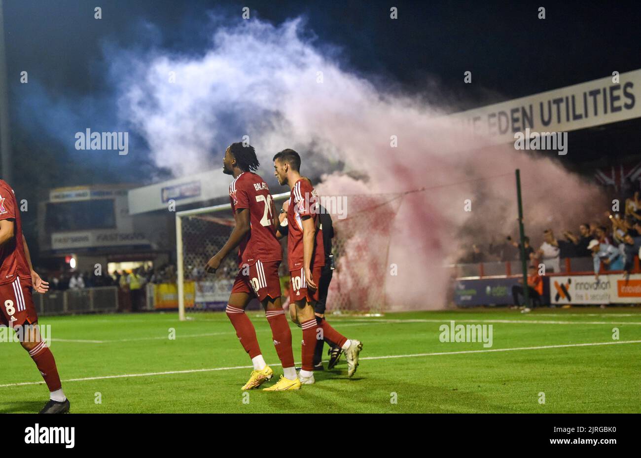 A smoke flare is let off after James Balagizi of Crawley had scored their second goal during the EFL Carabao Cup Round Two match between Crawley Town and Fulham at the Broadfield Stadium  , Crawley ,  UK - 23rd August 2022  Editorial use only. No merchandising. For Football images FA and Premier League restrictions apply inc. no internet/mobile usage without FAPL license - for details contact Football Dataco Stock Photo