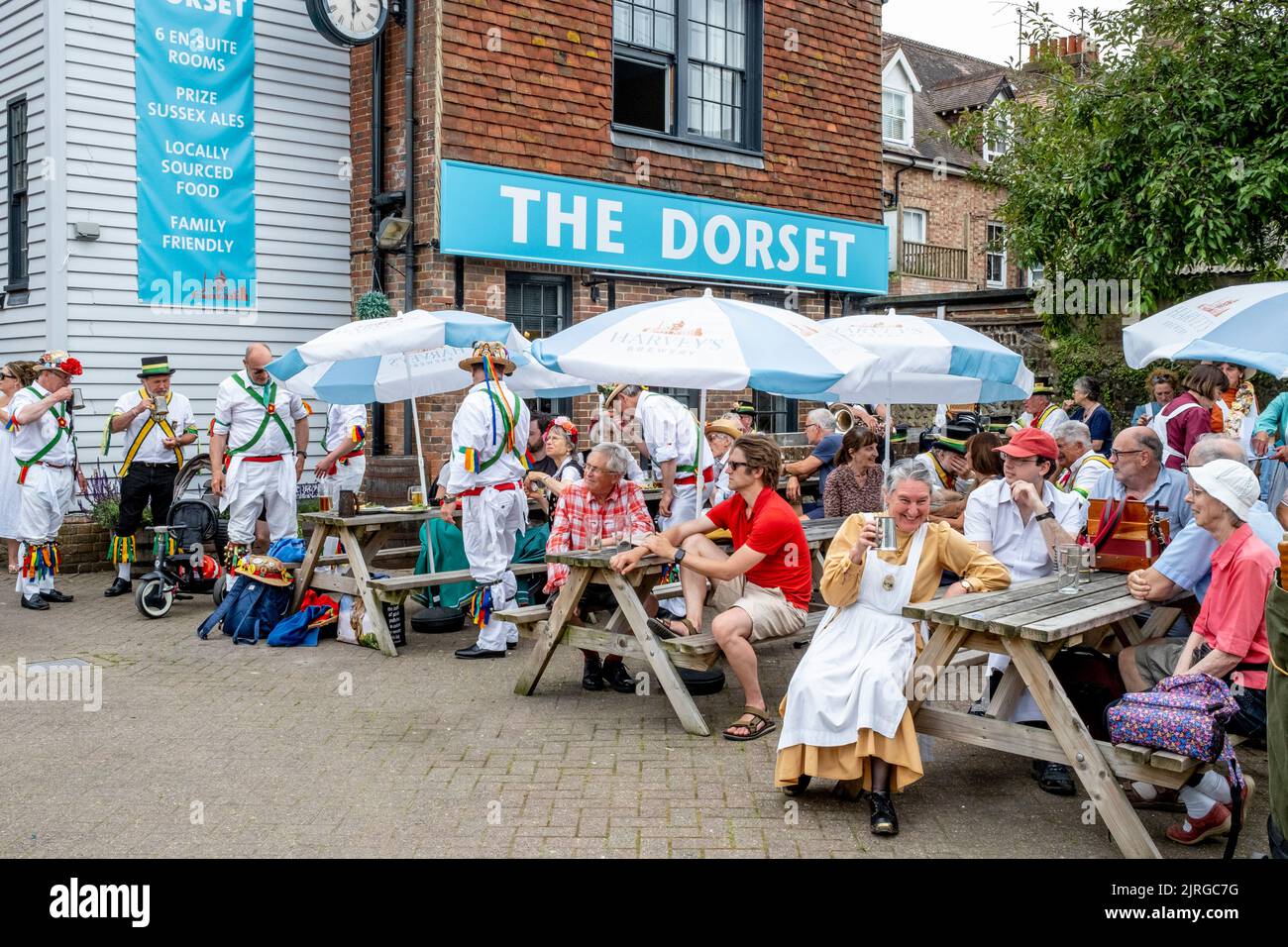 A Group Of Morris Dancers Drinking Beer Outside The Dorset Pub, Lewes, East Sussex, UK. Stock Photo