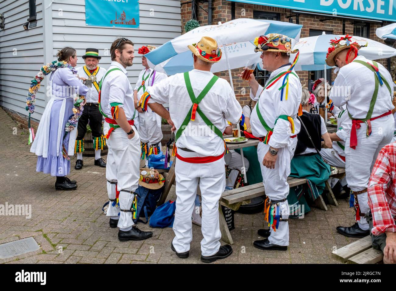 A Group Of Morris Dancers Socialising Outside The Dorset Pub, Lewes, East Sussex, UK. Stock Photo