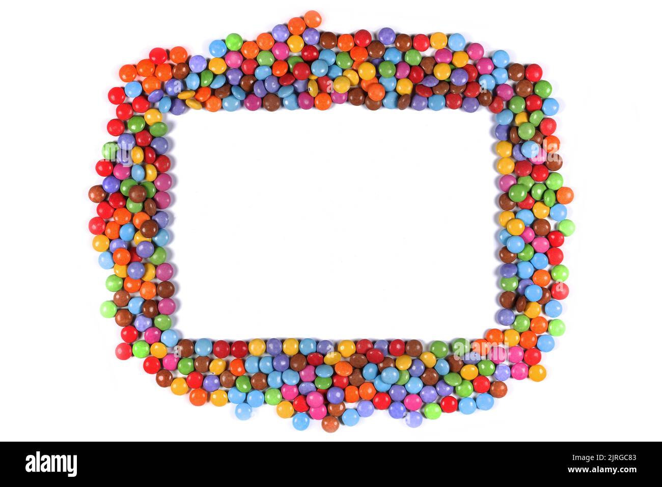 Frame border of multi coloured halloween candy sweets on white Stock Photo