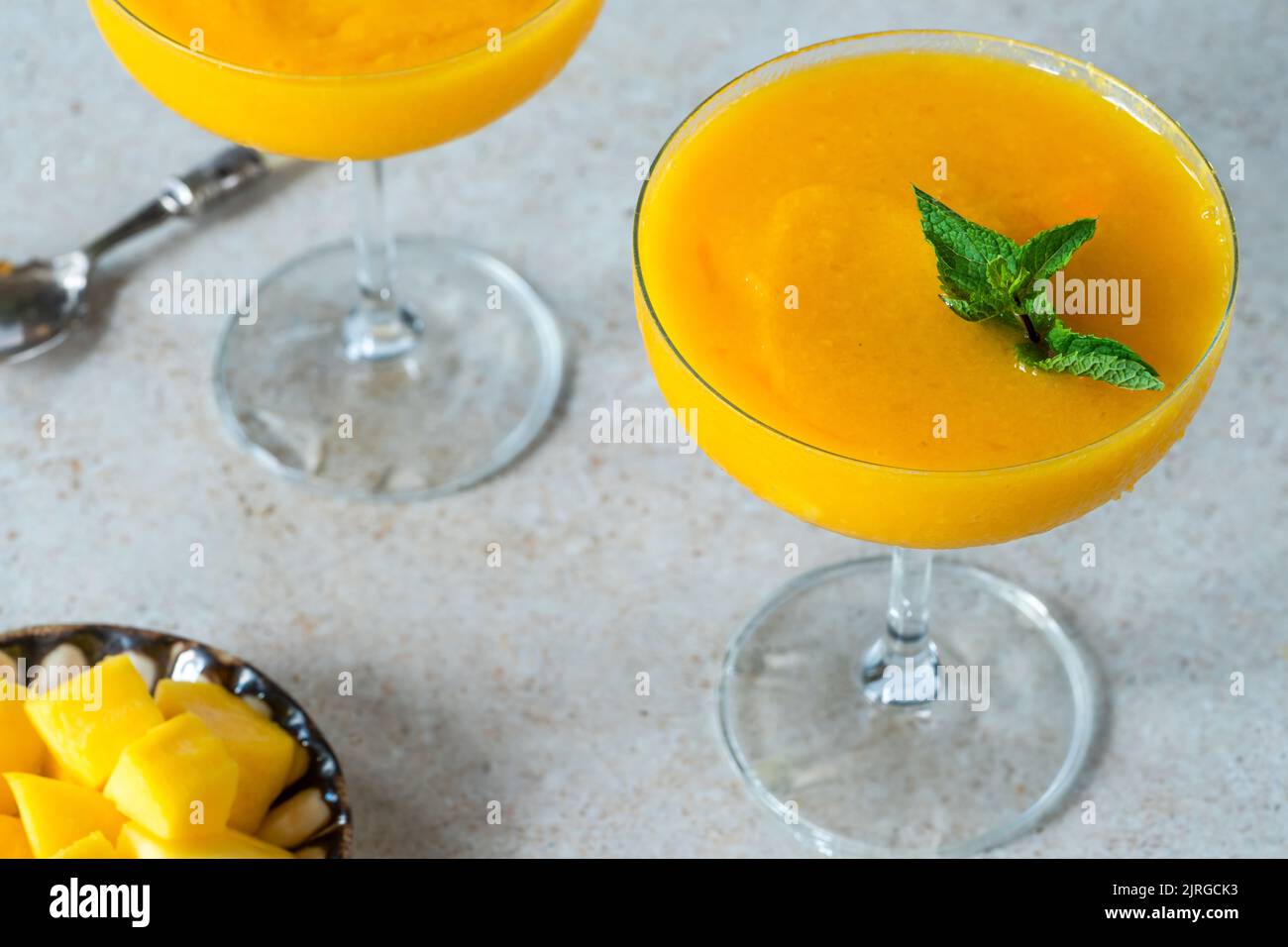 Frozen mango daiquiri with white rum garnished with fresh mint Stock