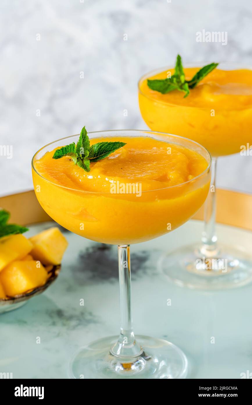 Frozen mango daiquiri with white rum garnished with fresh mint Stock