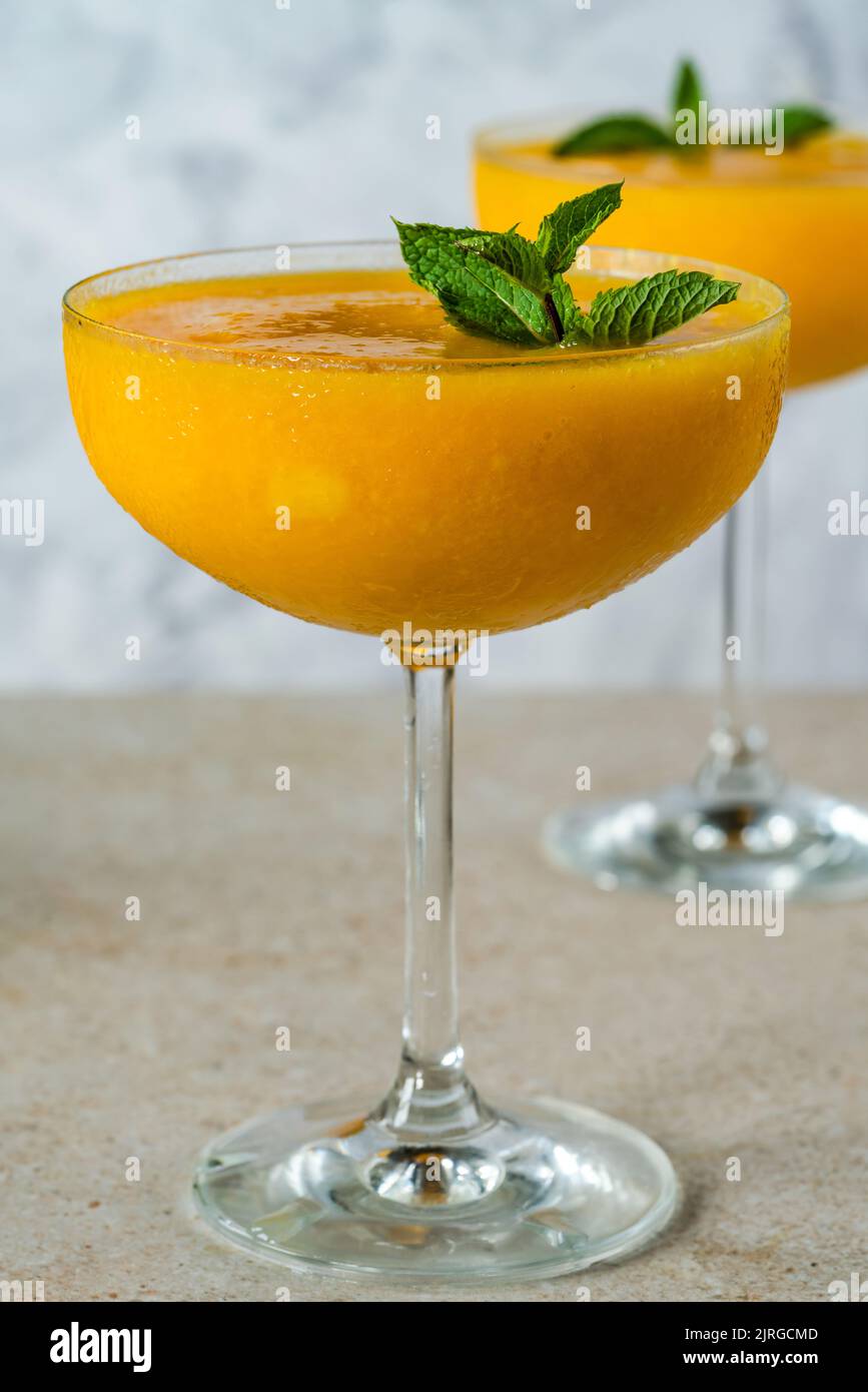 Frozen mango daiquiri with white rum garnished with fresh mint Stock