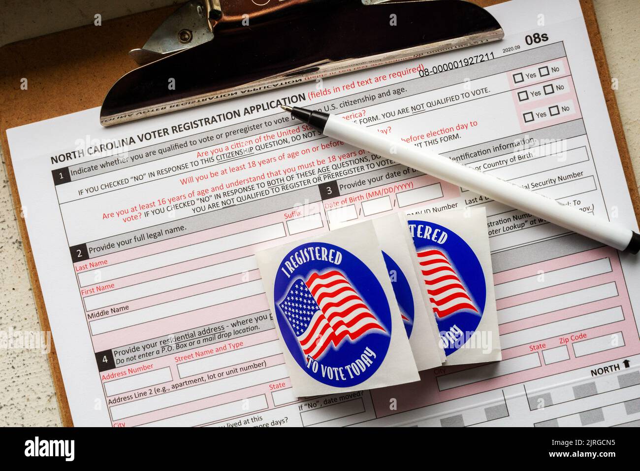 Supplies to register voters--a clipboard of NC voter registration forms, stickers, and a pen--are ready for the US 2022 mid-terms. Stock Photo