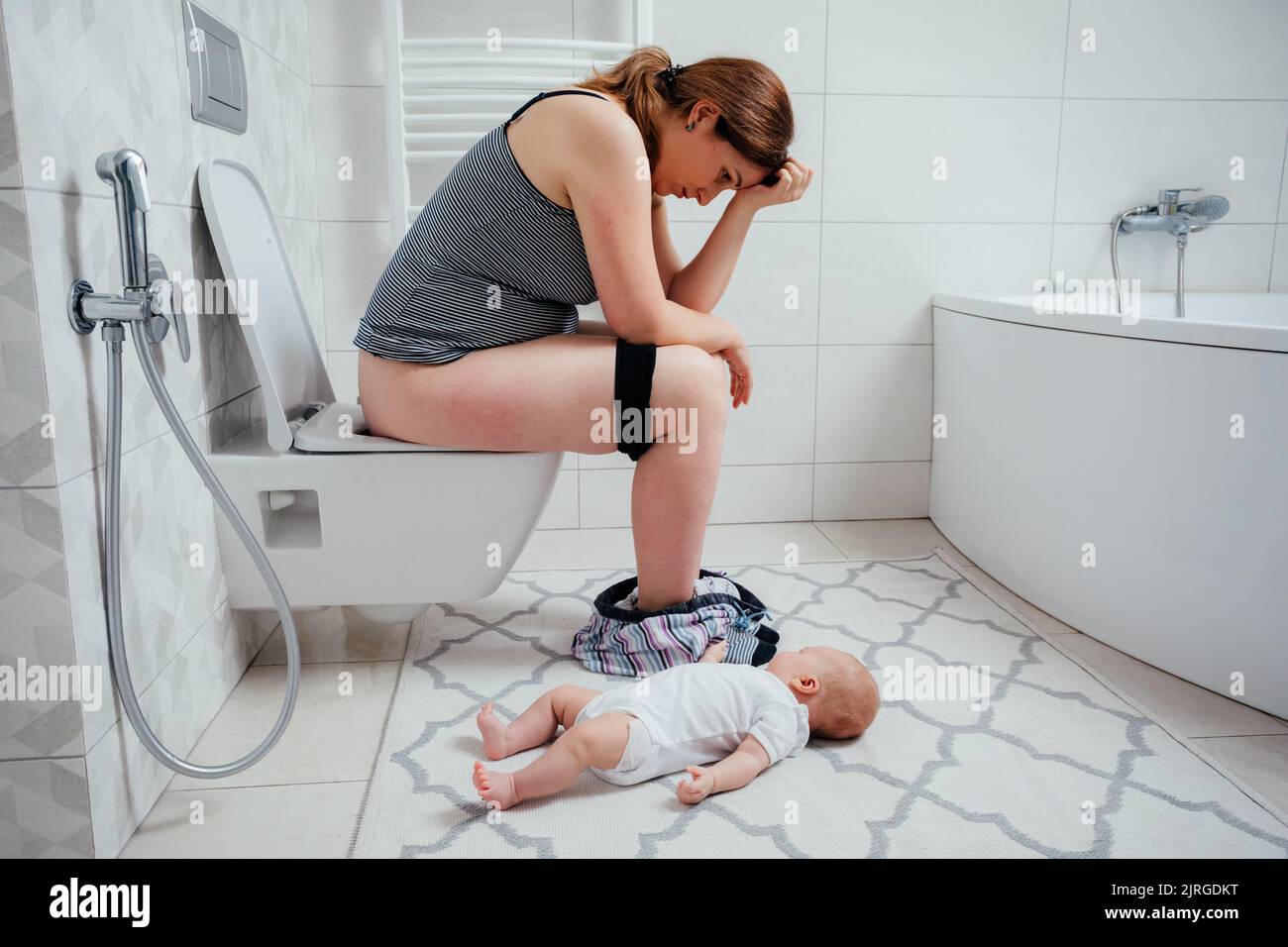 Tired depressed mother with crying newborn baby Stock Photo