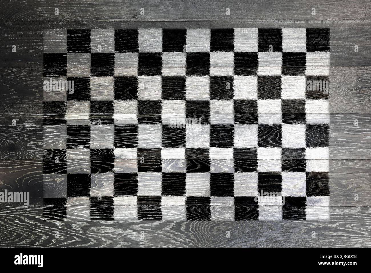 Chequered flag on rustic old wood surface background Stock Photo