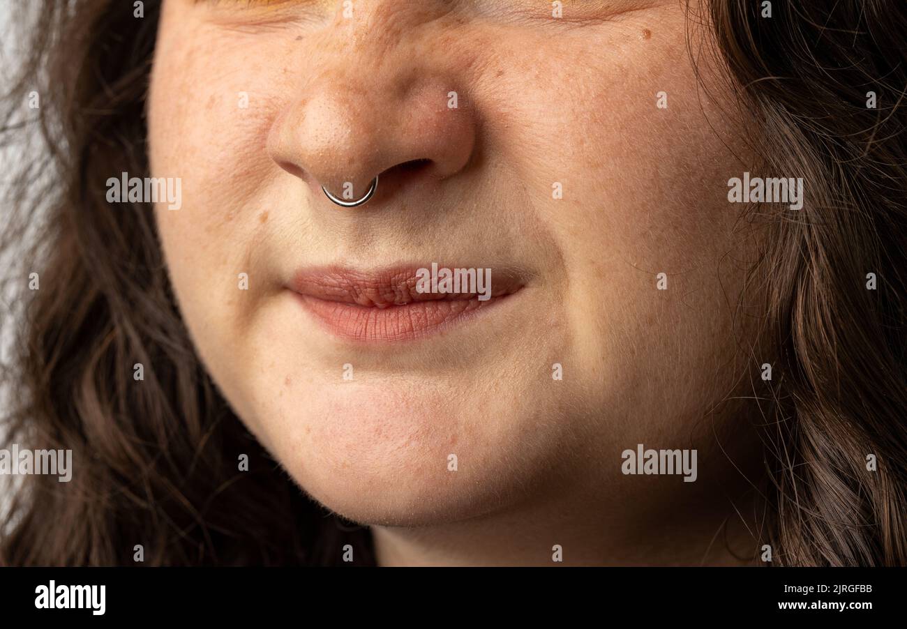 Close Up of young woman turning up her nose Stock Photo