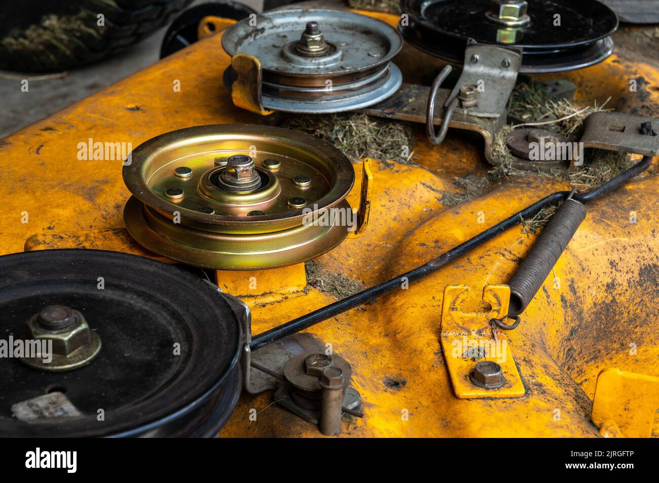 Lawn mower deck and new idler pulley. Lawn equipment maintenance repair