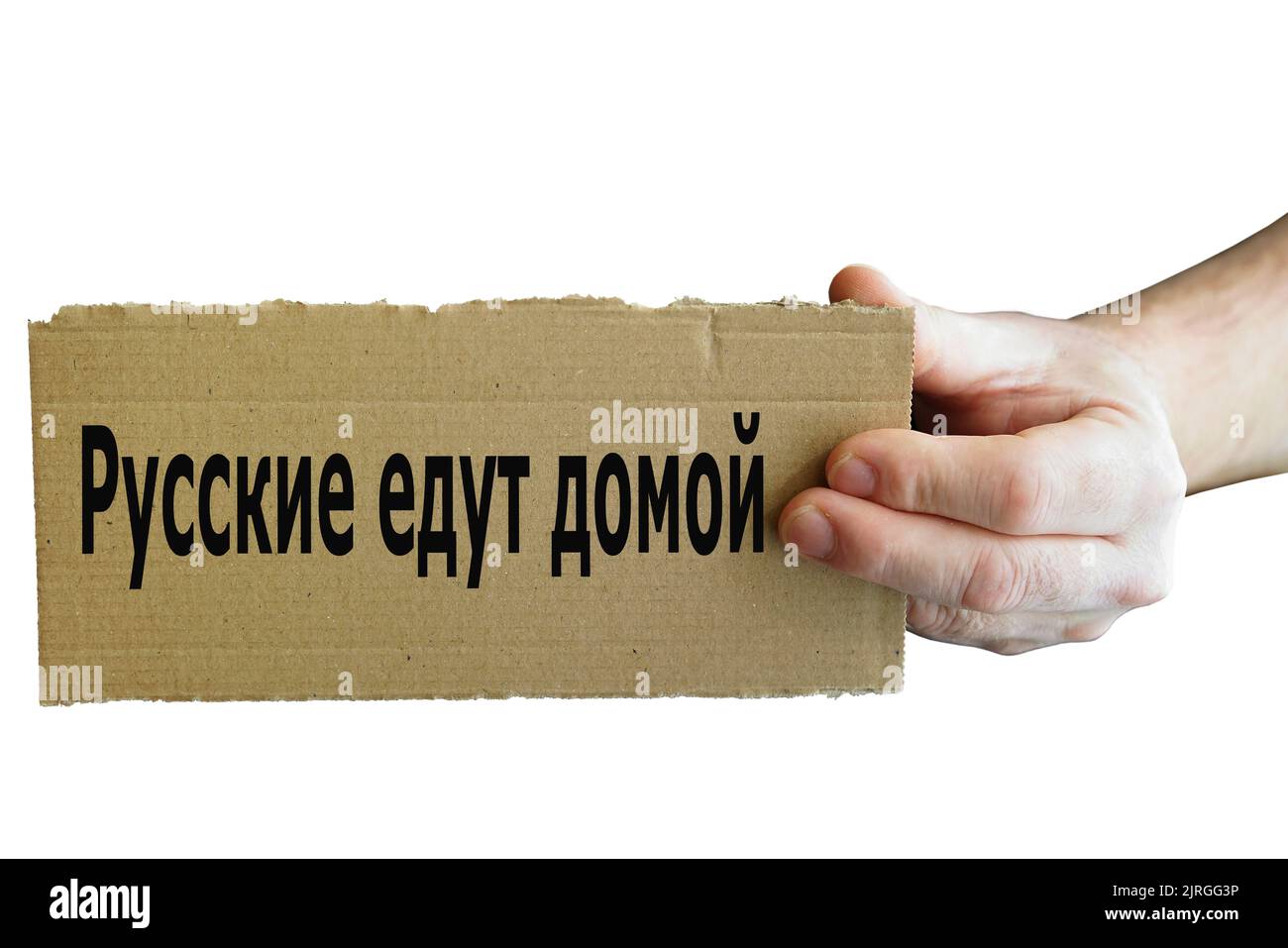 Sign from cardboard in Russian language in one hand with inscription Russians go home Stock Photo