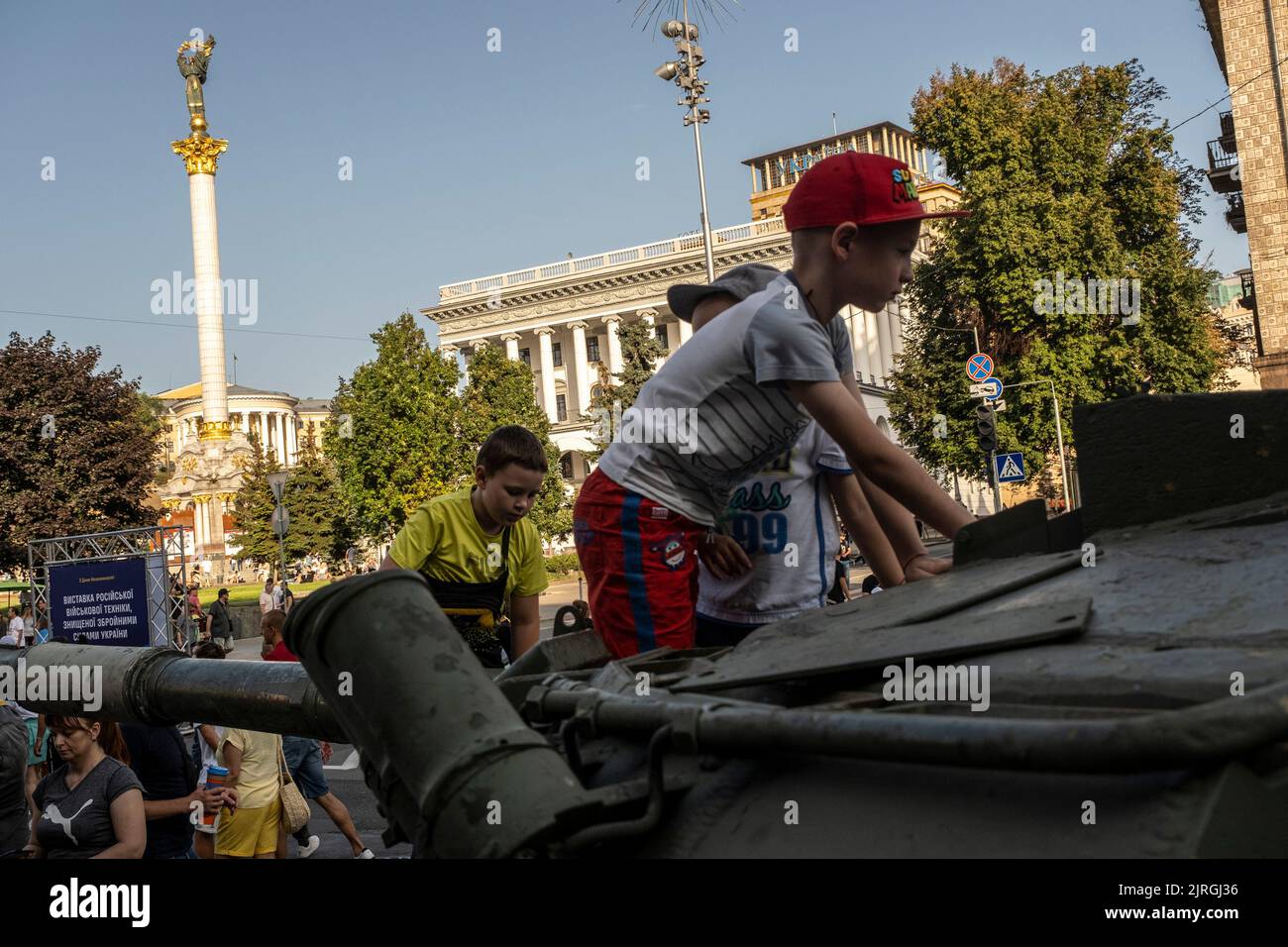 Kyiv, Kyiv Oblast, Ukraine. 21st Aug, 2022. Children climb the display of a destroyed Russian tank on the streets of Kyiv. As dedicated to the upcoming Independence Day of Ukraine, and nearly 6 months after the full-scale invasion of Ukraine on February 24, the country's capital Kyiv holds an exhibition on the main street of Khreschaytk Street showing multiple destroyed military equipment, tanks and weapons from The Armed Forces of The Russian Federation (AFRF).As the Russian full invasion of Ukraine started on February 24, the war that has killed numerous civilians and soldiers, nearly 900 Stock Photo
