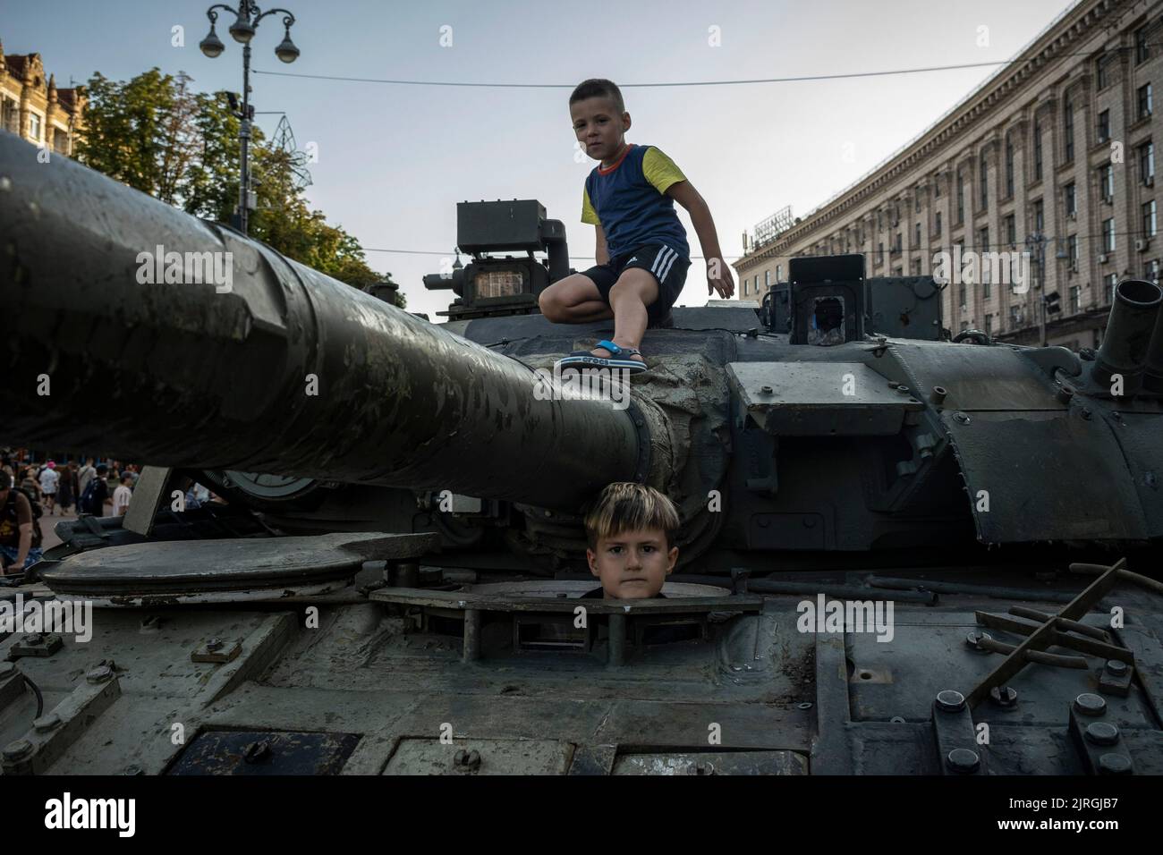 Kyiv, Kyiv Oblast, Ukraine. 21st Aug, 2022. Children climb and explore the display of a destroyed Russian tank turret on the streets of Kyiv. As dedicated to the upcoming Independence Day of Ukraine, and nearly 6 months after the full-scale invasion of Ukraine on February 24, the country's capital Kyiv holds an exhibition on the main street of Khreschaytk Street showing multiple destroyed military equipment, tanks and weapons from The Armed Forces of The Russian Federation (AFRF).As the Russian full invasion of Ukraine started on February 24, the war that has killed numerous civilians and so Stock Photo