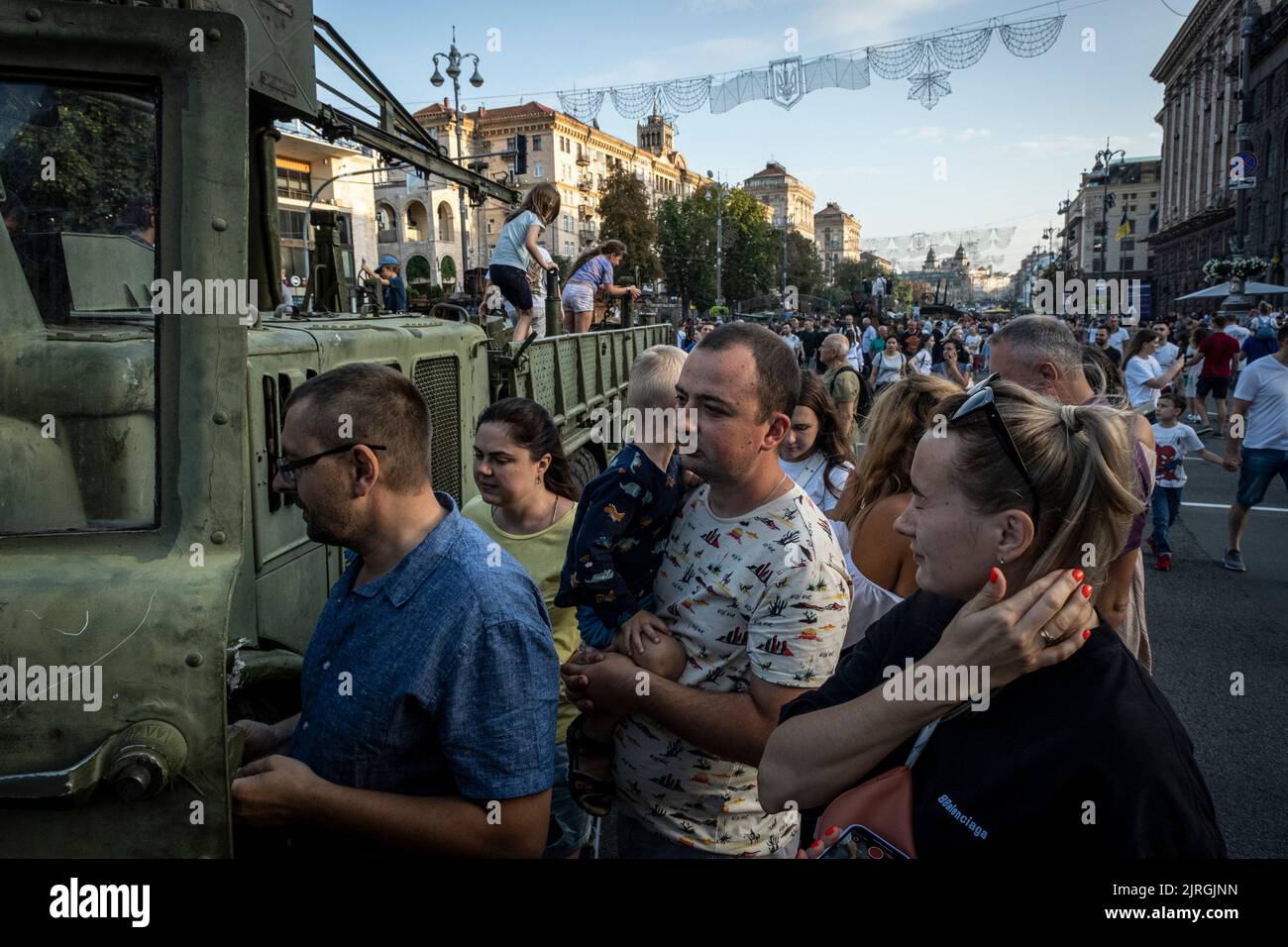 Kyiv, Kyiv Oblast, Ukraine. 21st Aug, 2022. Parents along with their children lined up to see the interior of a destroyed Russian military vehicle on the streets of Kyiv. As dedicated to the upcoming Independence Day of Ukraine, and nearly 6 months after the full-scale invasion of Ukraine on February 24, the country's capital Kyiv holds an exhibition on the main street of Khreschaytk Street showing multiple destroyed military equipment, tanks and weapons from The Armed Forces of The Russian Federation (AFRF).As the Russian full invasion of Ukraine started on February 24, the war that has kil Stock Photo