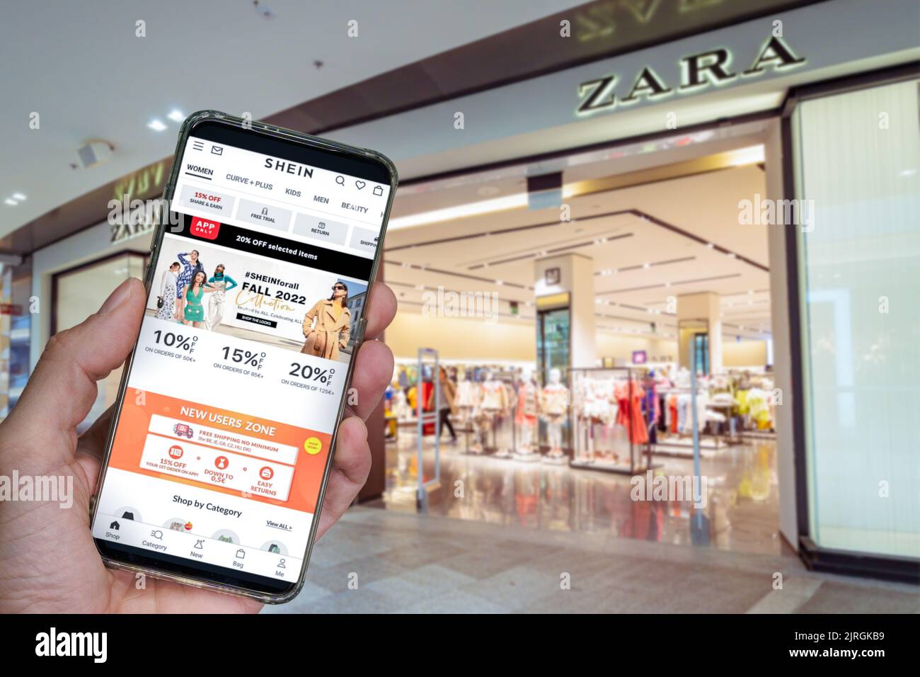 Zara Spanish clothes brand online delivery box. Hand on smartphone with  Inditex retailer collection web page, above delivered order package with  logo Stock Photo - Alamy