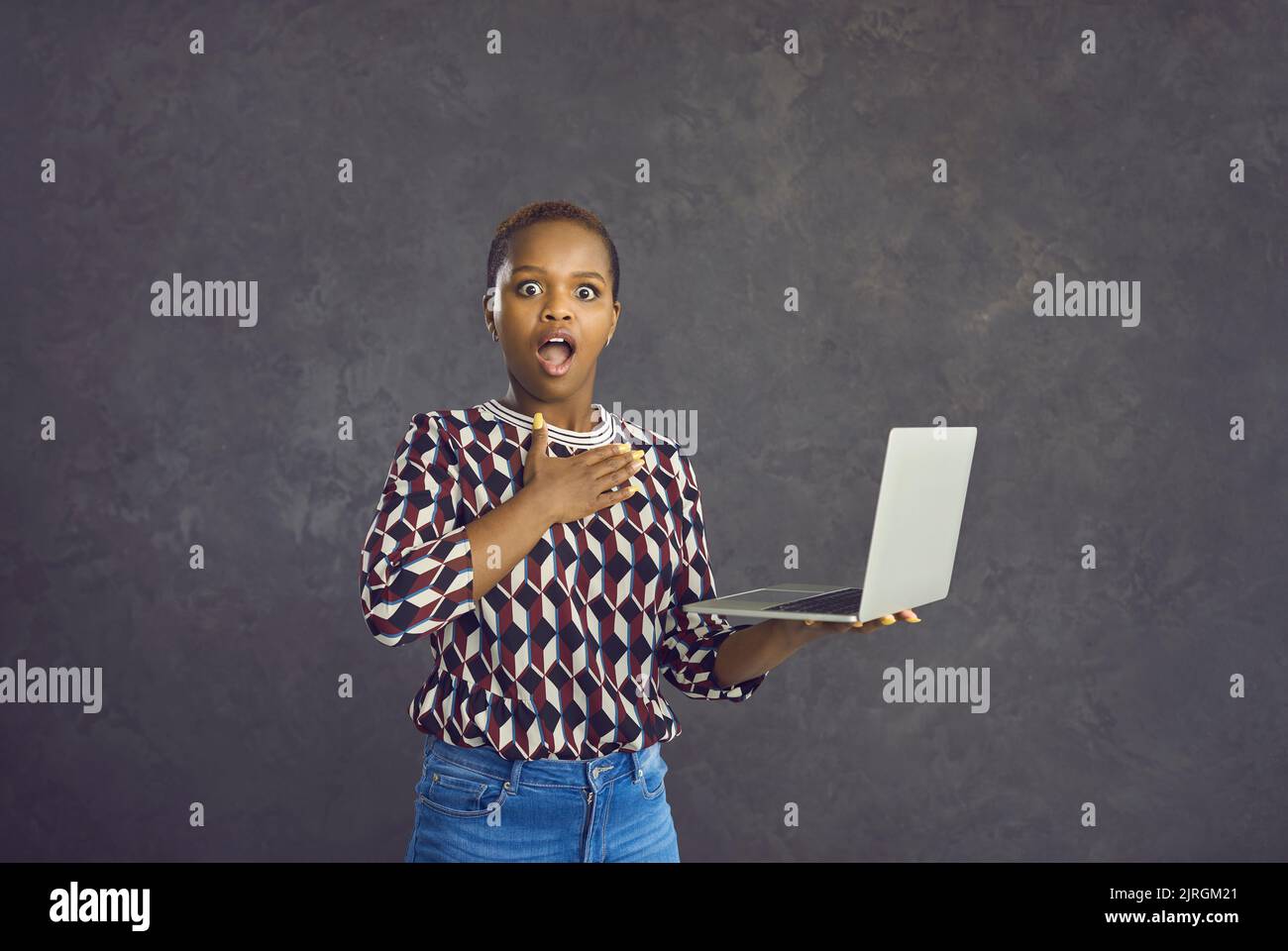 Portrait of shocked biracial woman stunned by online deal Stock Photo