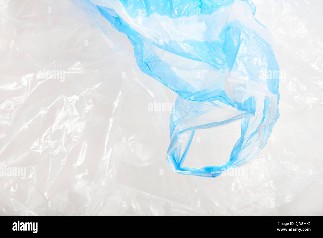 Plastic single use bags. Blue and white wrinkled background. Concepts