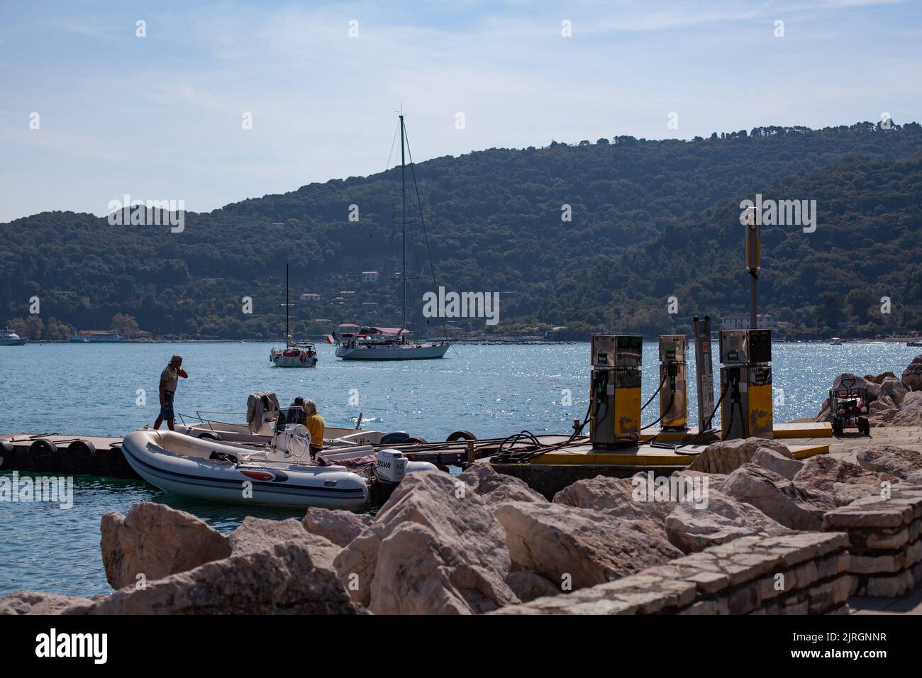 Boat filling up at harbour fuel station, Italy Stock Photo