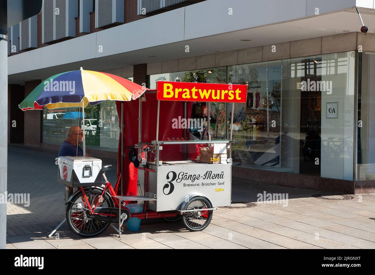 Wolfsburg, Germany - August 12, 2022: A street seller of grilled German bratwurst sausages Stock Photo