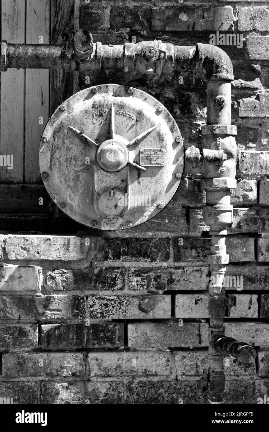 Old gas control valve on wall. Stock Photo