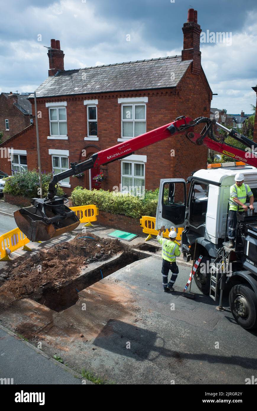A road under excavation by water company United Utilities who are repairing an underground pipe in Barnton, Northwich Cheshire. Stock Photo