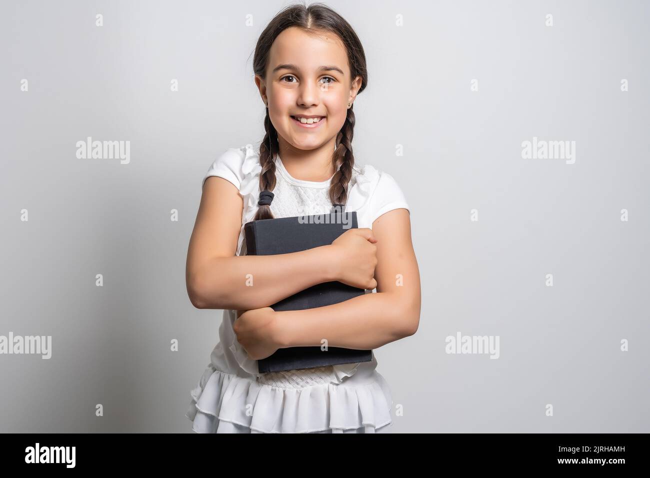 Portrait of a smiling little schoolgirl Stock Photo - Alamy