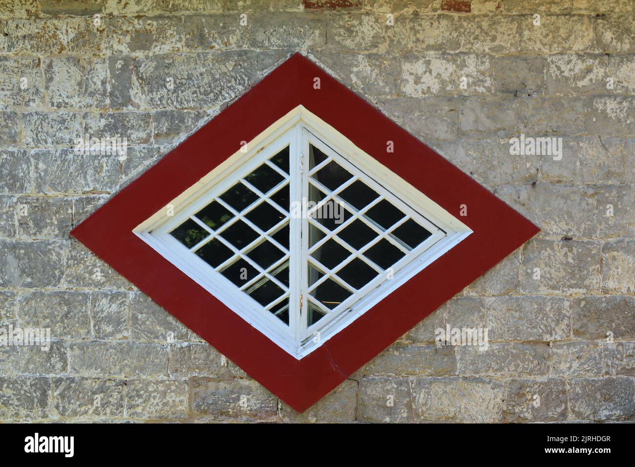 An unusual diamond shaped window on a historic house in Devon, England Stock Photo