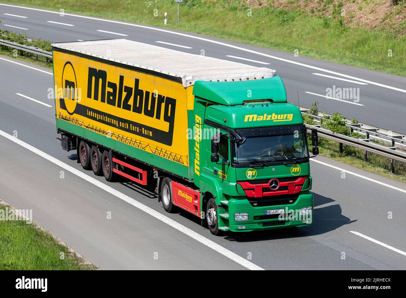 Malzburg Mercedes-Benz truck with tarpaulin trailer on motorway Stock Photo