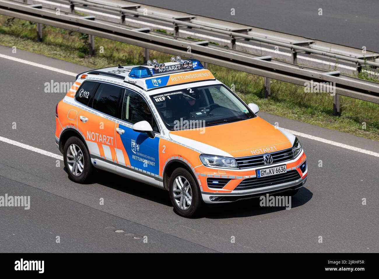 German emergency physician car of the Oberberg distict with active blue emergency lighting on motorway Stock Photo