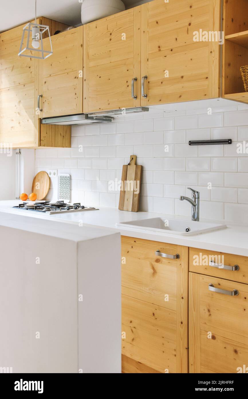 Studio apartment with white walls and open plan kitchen with sofa in