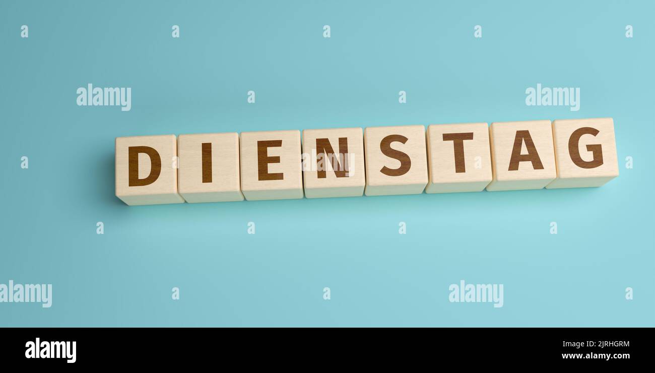 The German word Dienstag (Tuesday) built from letters on wooden cubes. High angle view with copy space Stock Photo